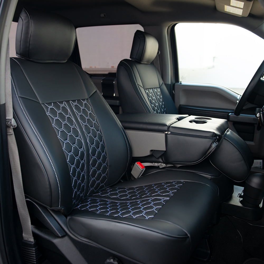 Custom black leather seat covers with a geometric pattern installed in a Ford F-150 truck interior.